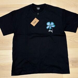 Stussy Black T-Shirt with Blue Flower Design